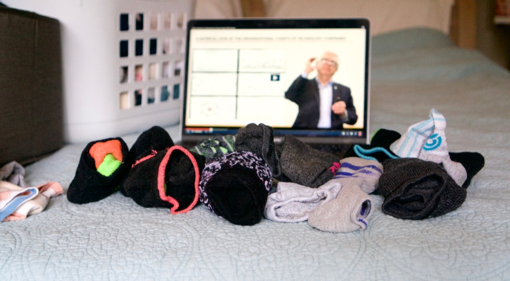 Socks on bed with laptop beside it